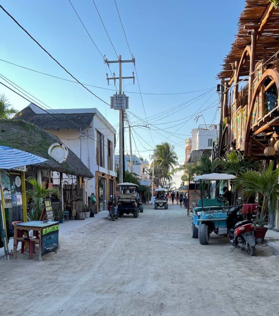 gulf carts parked on the side of the dirt roads in isla holbox mexico