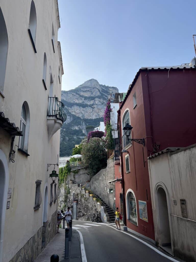 Narrow street in Positano Italy facing a high mountain