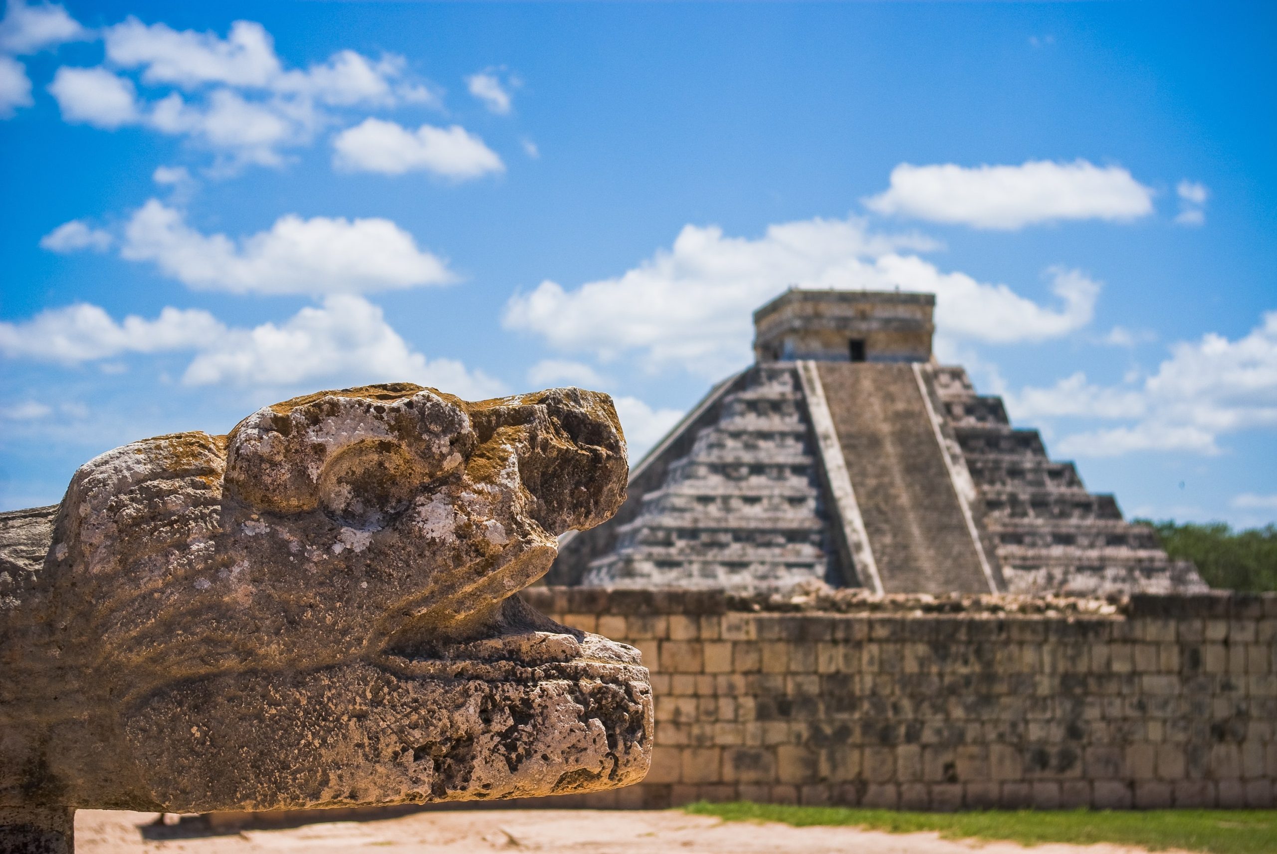 clear blue skies with the famous chichen itza pyramid in the background in merida mexico.