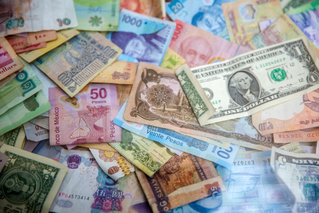 several worldwide fiat currencies layed out on a table