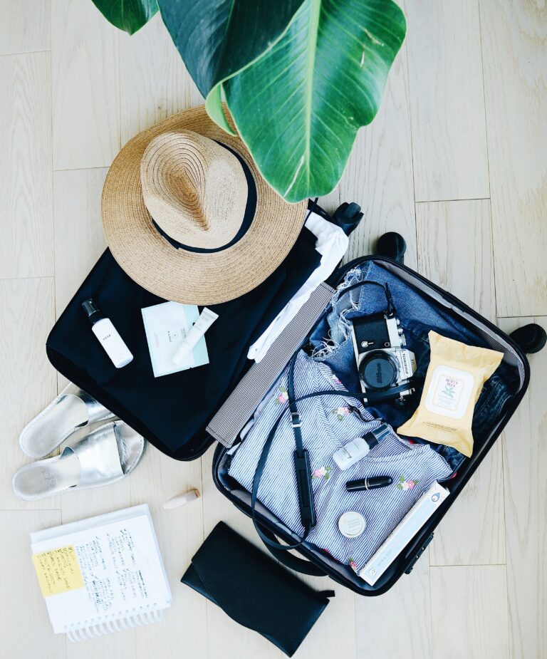 carry on luggage opened up being packed with various items for a trip abroad