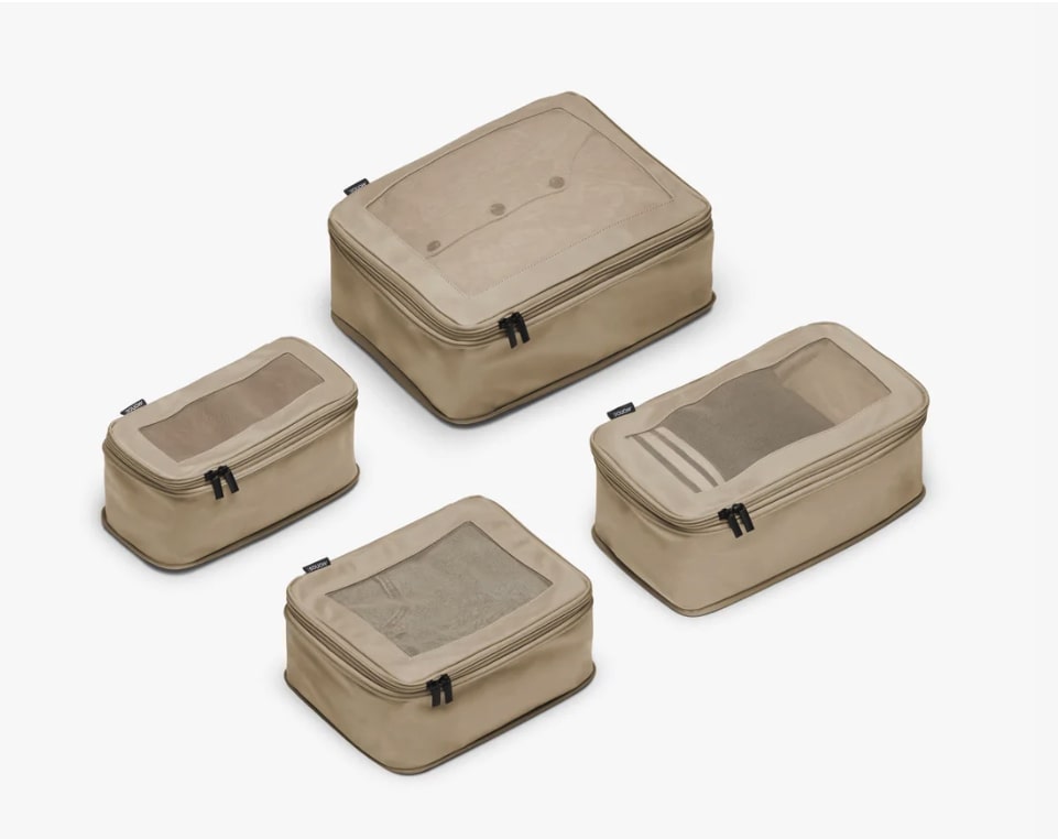 a set of four beige compression packing cubes from monos