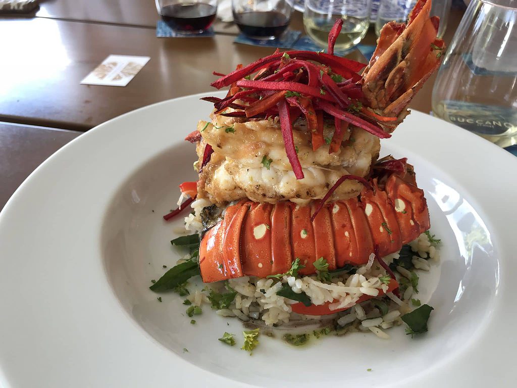 lobster and shrimp seafood dish with cooked rice and green herbs at buccanos cozumel