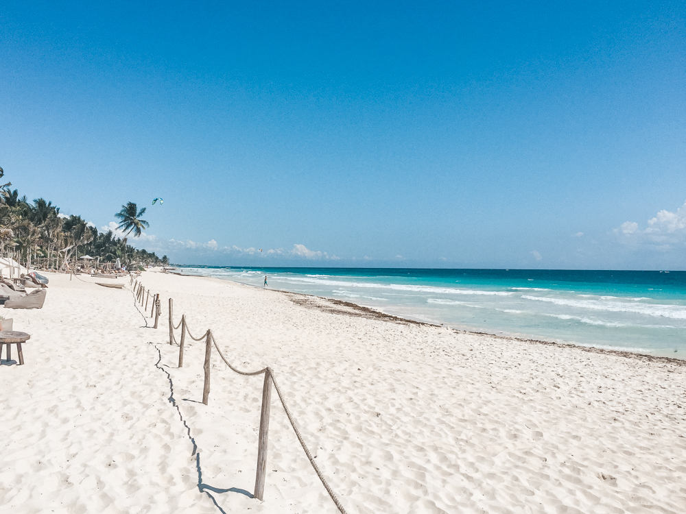 white sandy private beach area at nomade tulum beach club