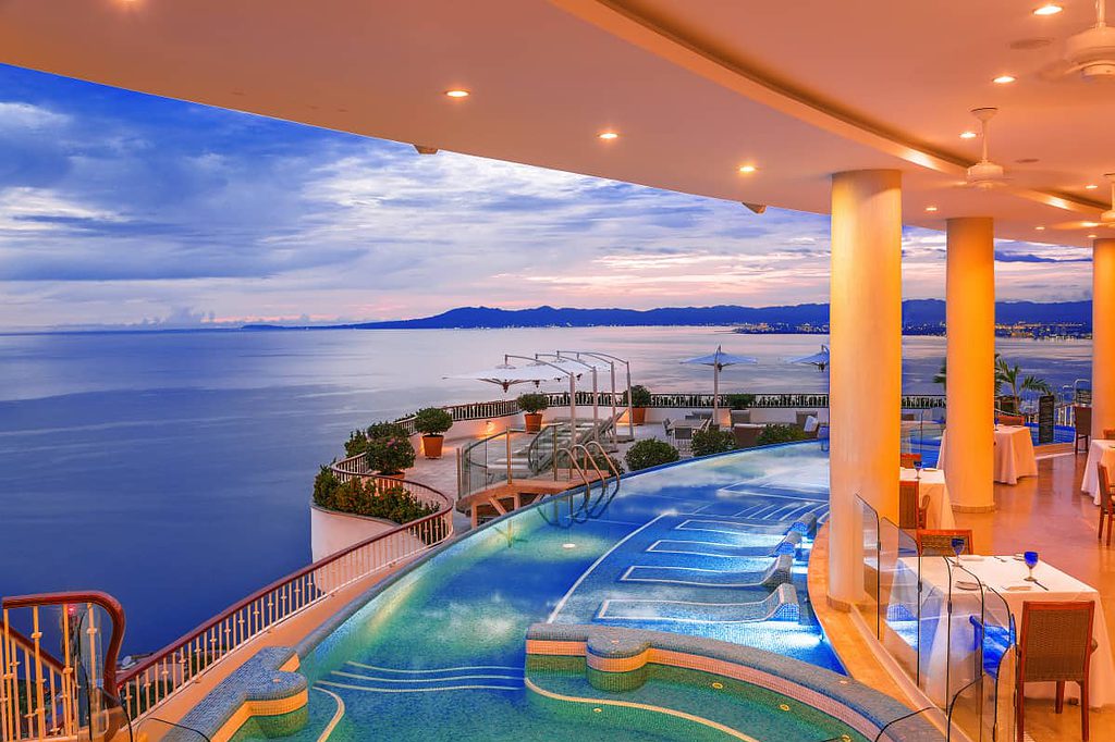 rooftop pool showcasing a stunning view of mountains and pacific ocean at the Grand Miramar in Puerto Vallarta