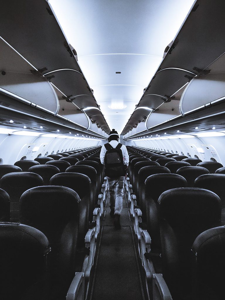 overhead bins on a plane all open, empty plane 