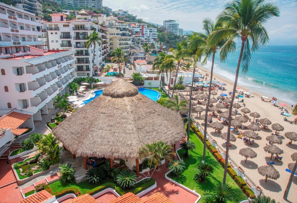 aerial view of the Tropicana hotel in Puerto Vallarta showcasing the beautiful beach full of palapas 