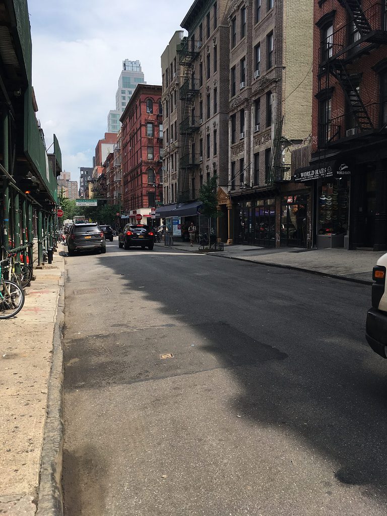 old style buildings on a busy street in the Lower East Side neighborhood of New York City