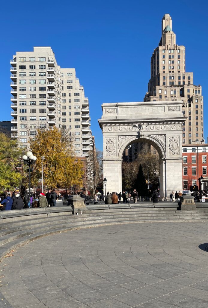 several tourists gather at Washington Square Park in New York City 