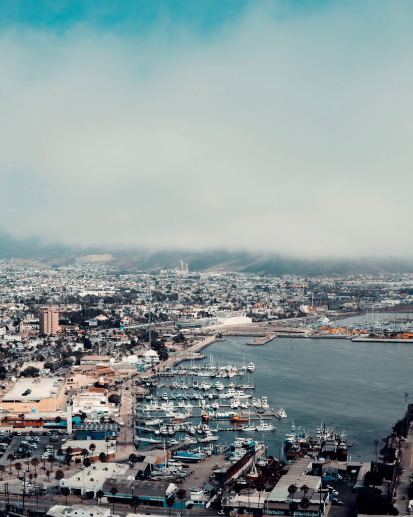 stunning views from the top of a hill showing the main town port full of boats docked along the water in Ensenada, Mexico