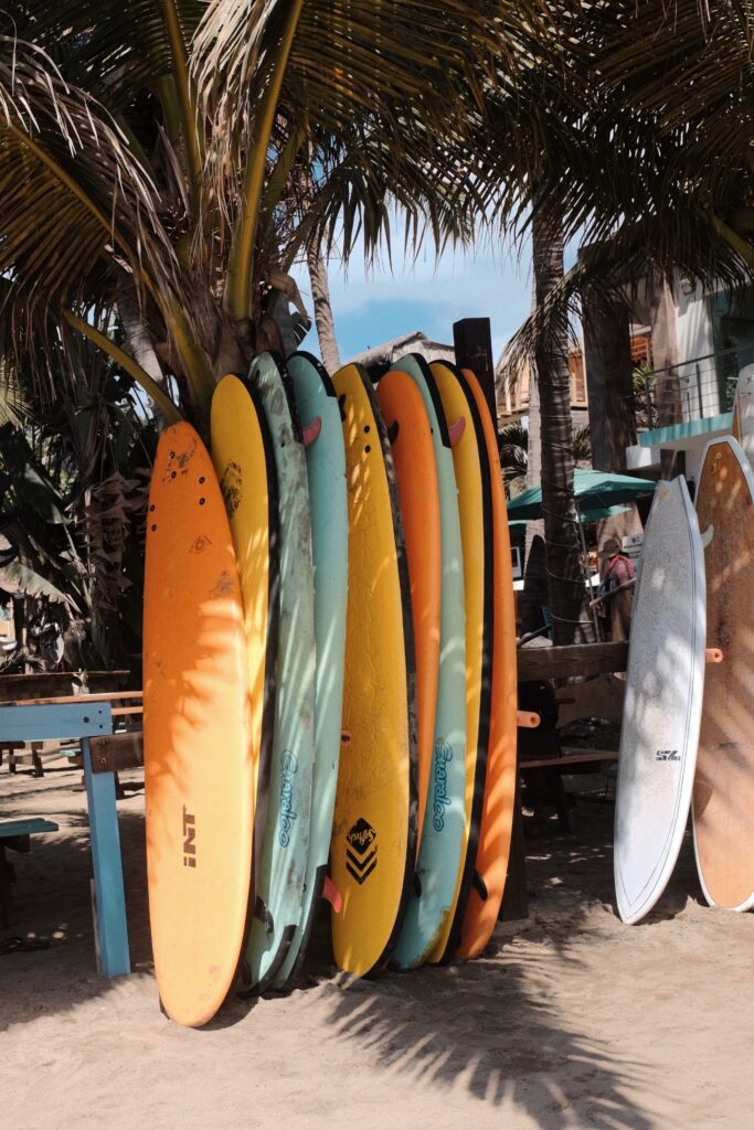 several surfboards standing upwards not being used in sayulita