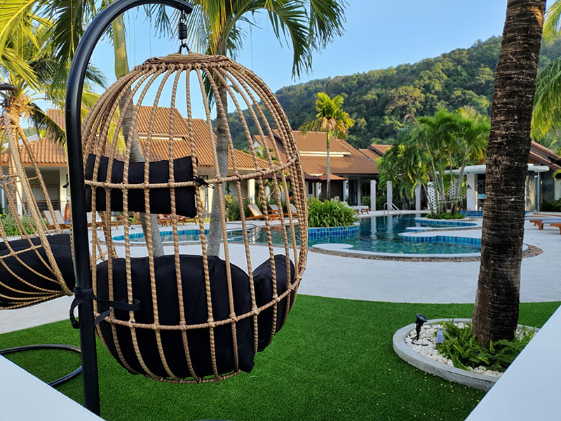 pool area alongside villas and mountainous range in the background at Blu Pine Villa Kata Beach
