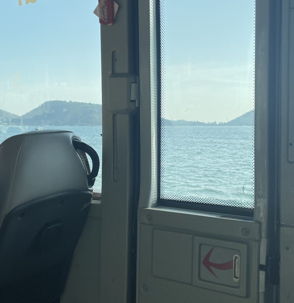 views of mountains and the ocean from the interior of the Phuket Smart Bus