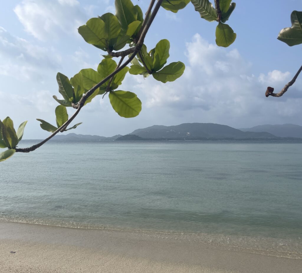 calm shallow beach with mountainous views in the distance Island in Samui District 