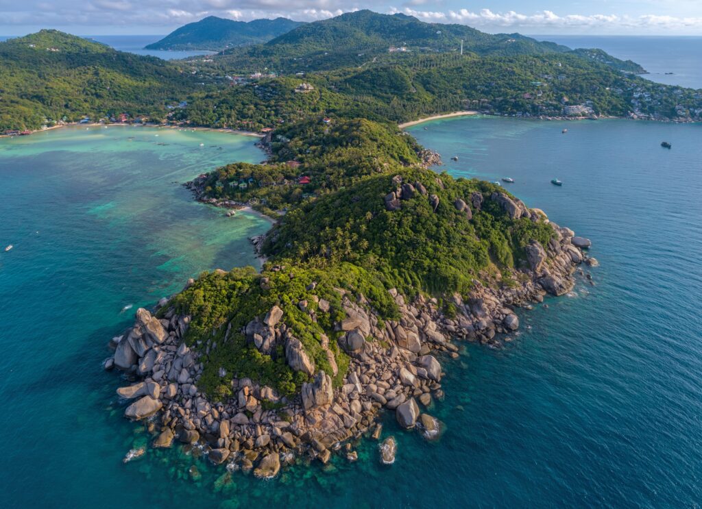 aerial views of luscious green forest along the coastline of Koh Tao island in the Gulf of Thailand  