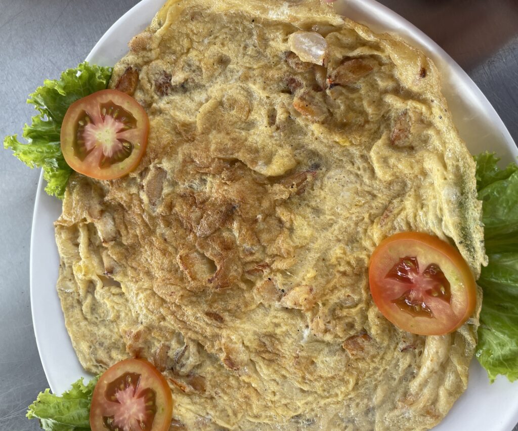 traditional crab omelet full of crab meat and tomato, lettuce on the side at Mama Jin in Karon Beach, Phuket 