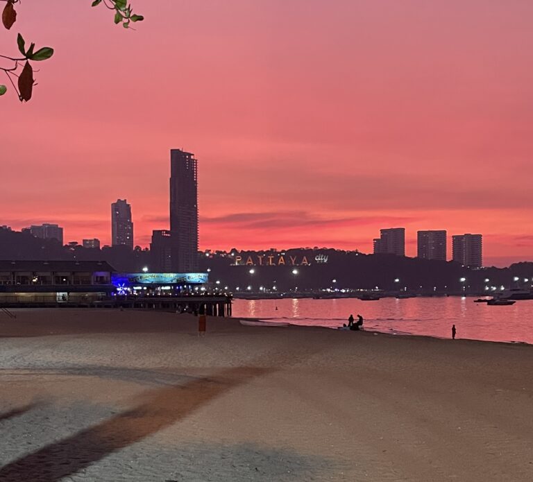 stunning orange sunset at Pattaya Beach with skyscrappers in the distance among the Pattaya City sign / Is Pattaya worth visiting?
