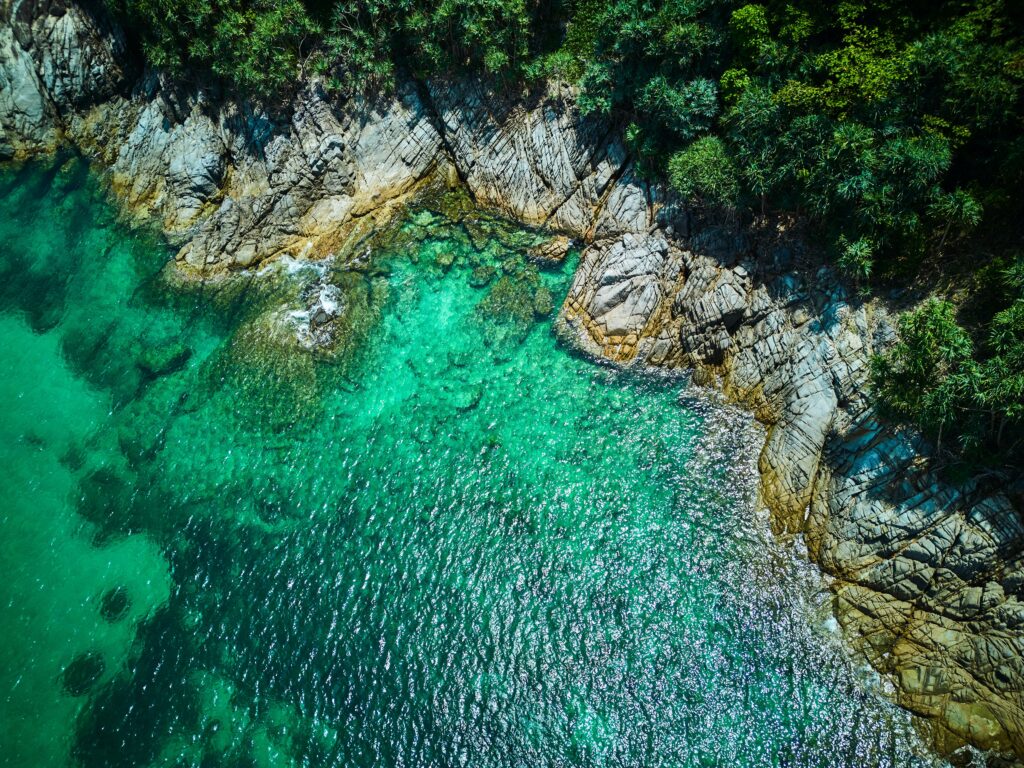 aerial view of the several shades of turquoise waters at Racha Island, an island close to Phuket 