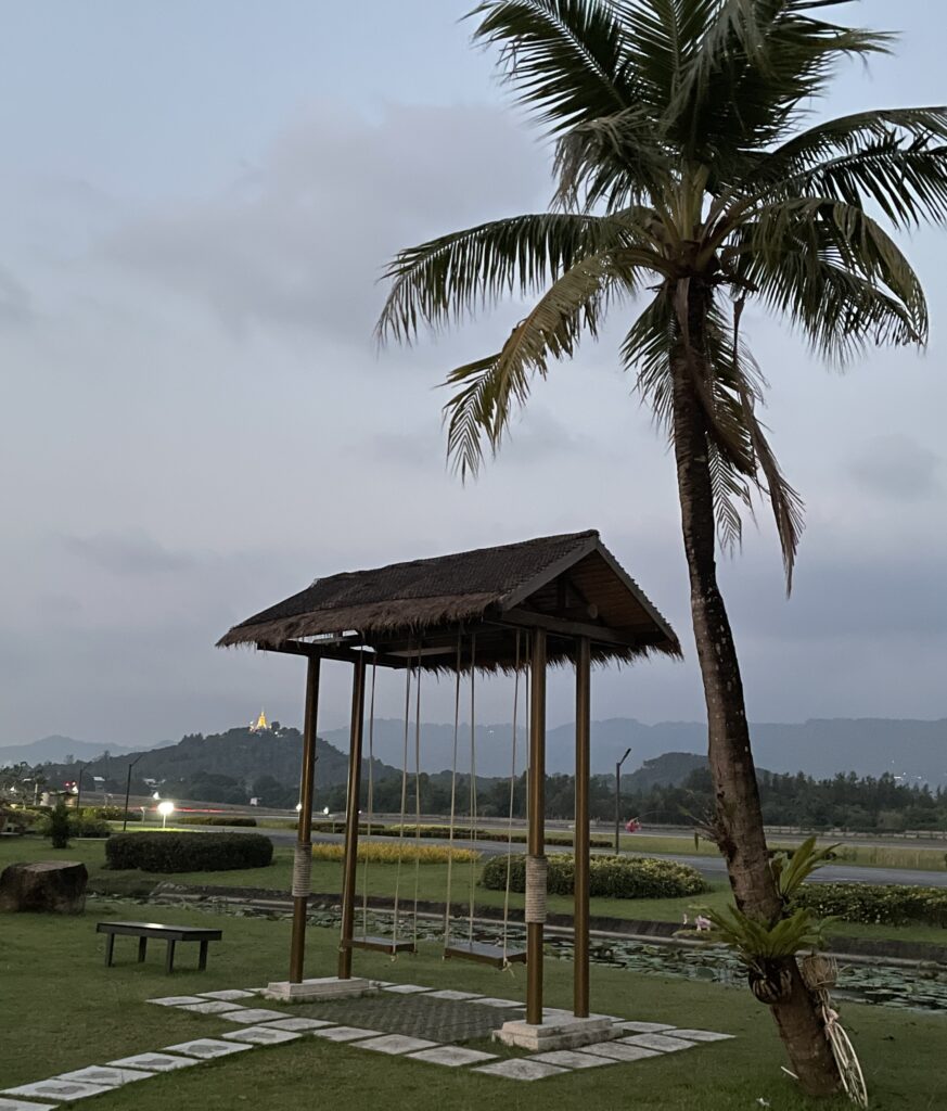 the airplane runway at Samui International Airport, surrounded with mountains and palm trees in the background in Koh Samui, Thailand