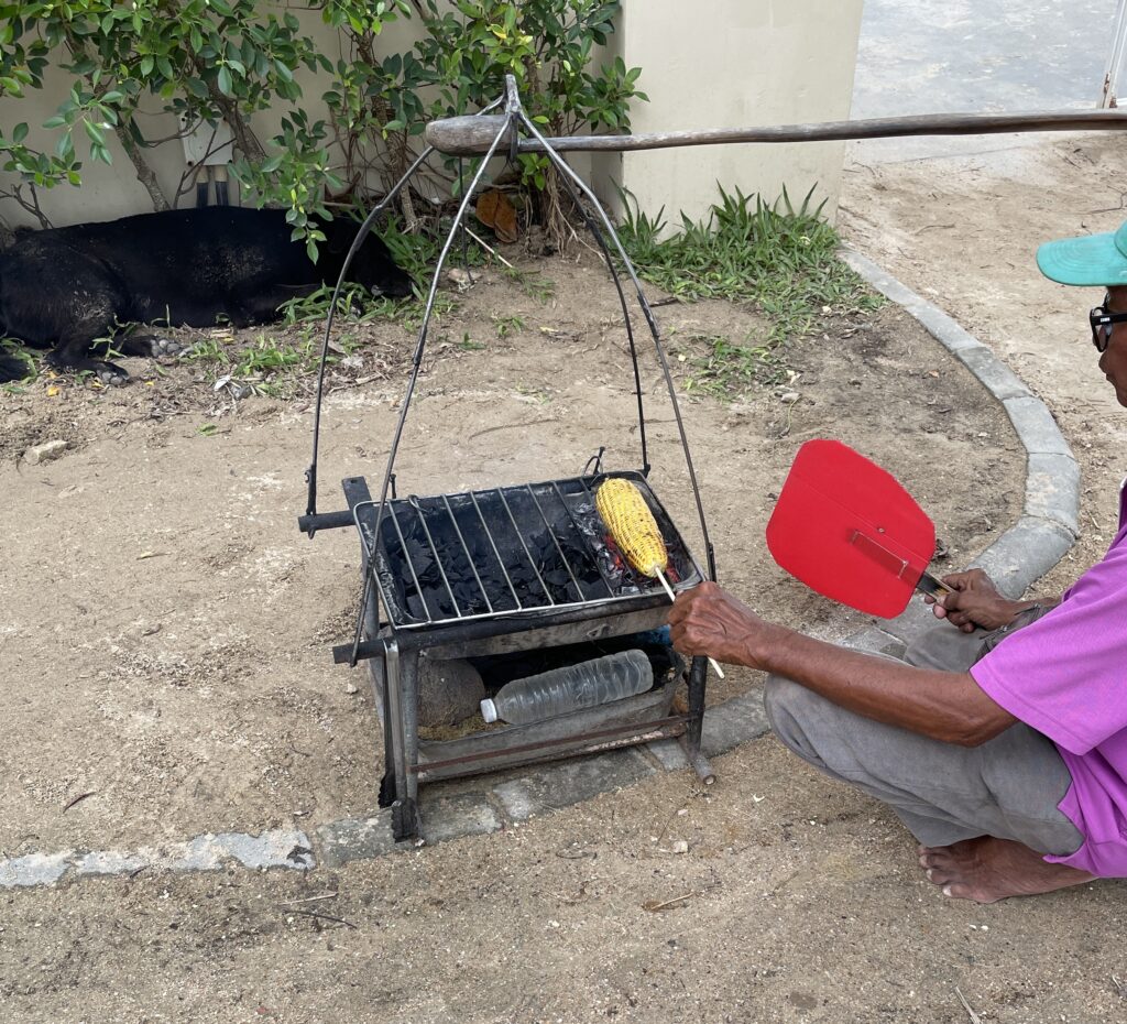 a man cooking corn with coconut charcoal, famous in Ao Nang for his cooked corn