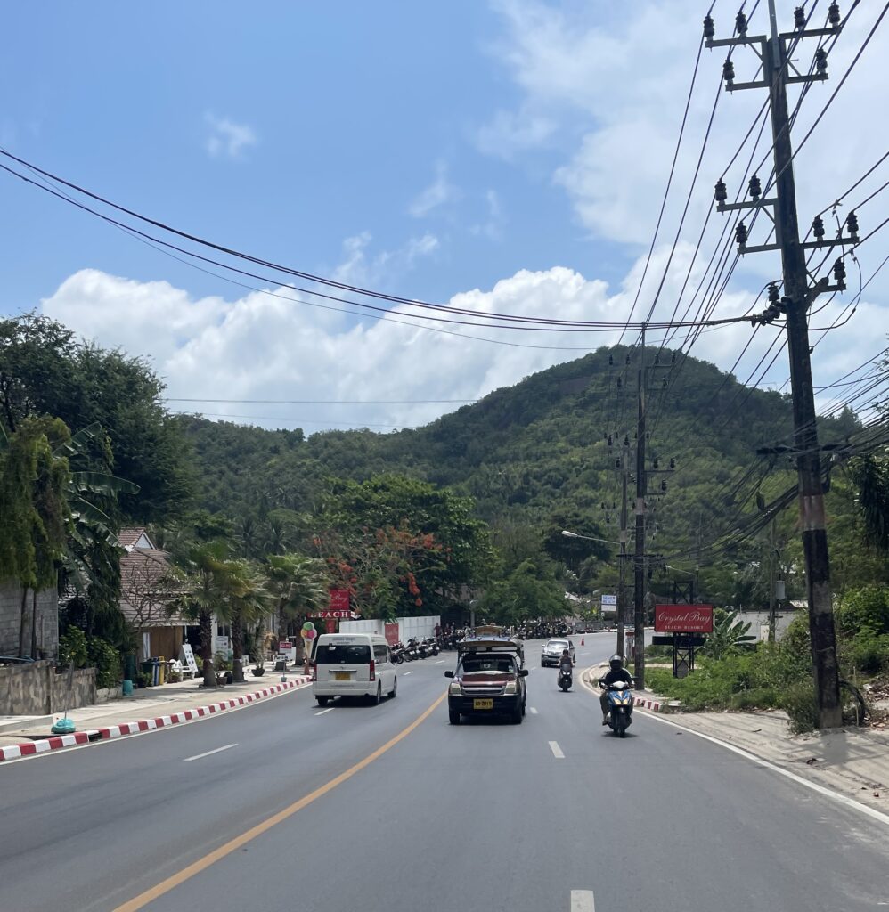 streets of Koh Samui on the main road along with mountains and clear skies in the background