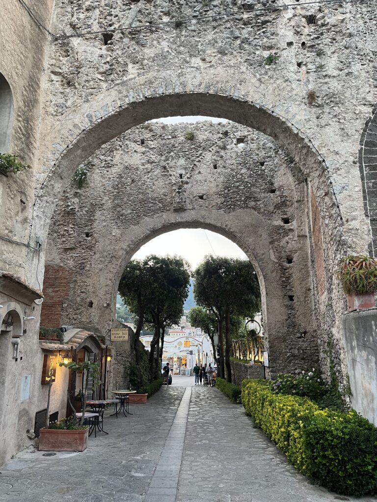 beautiful walkway with stone arches from above and greenery in Ravello, Italy 