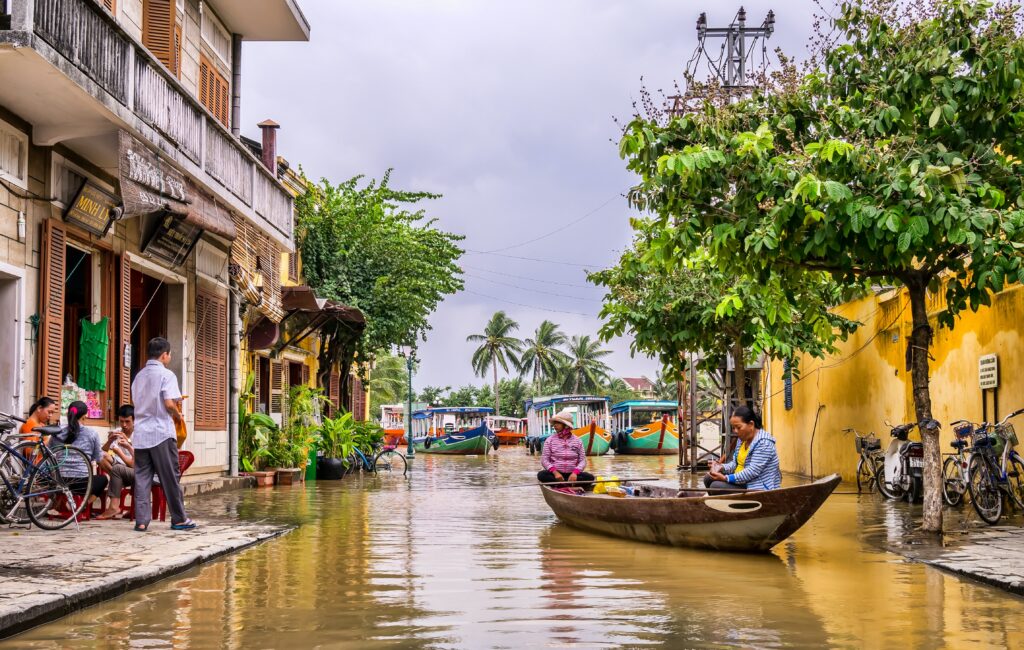 locals sitting on a Vietnamese style boat on a cloudy day in Hoi An, Vietnam 