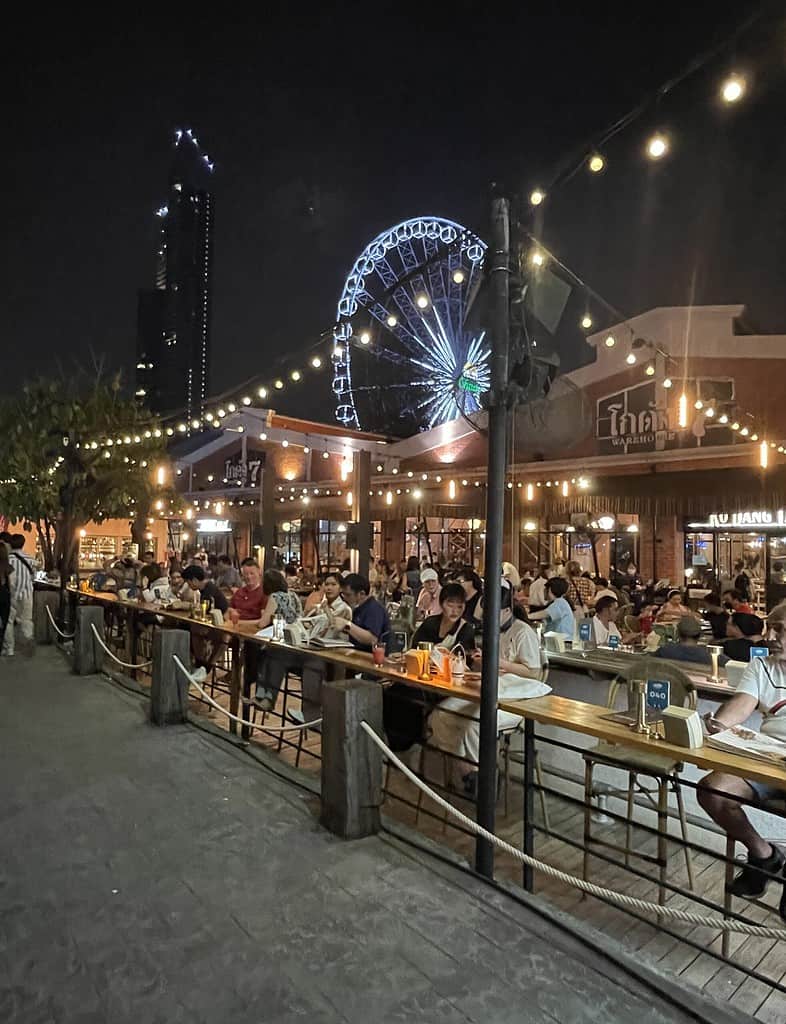 several tourist dining at a restaurant at the popular Asiatique Riverfront market 