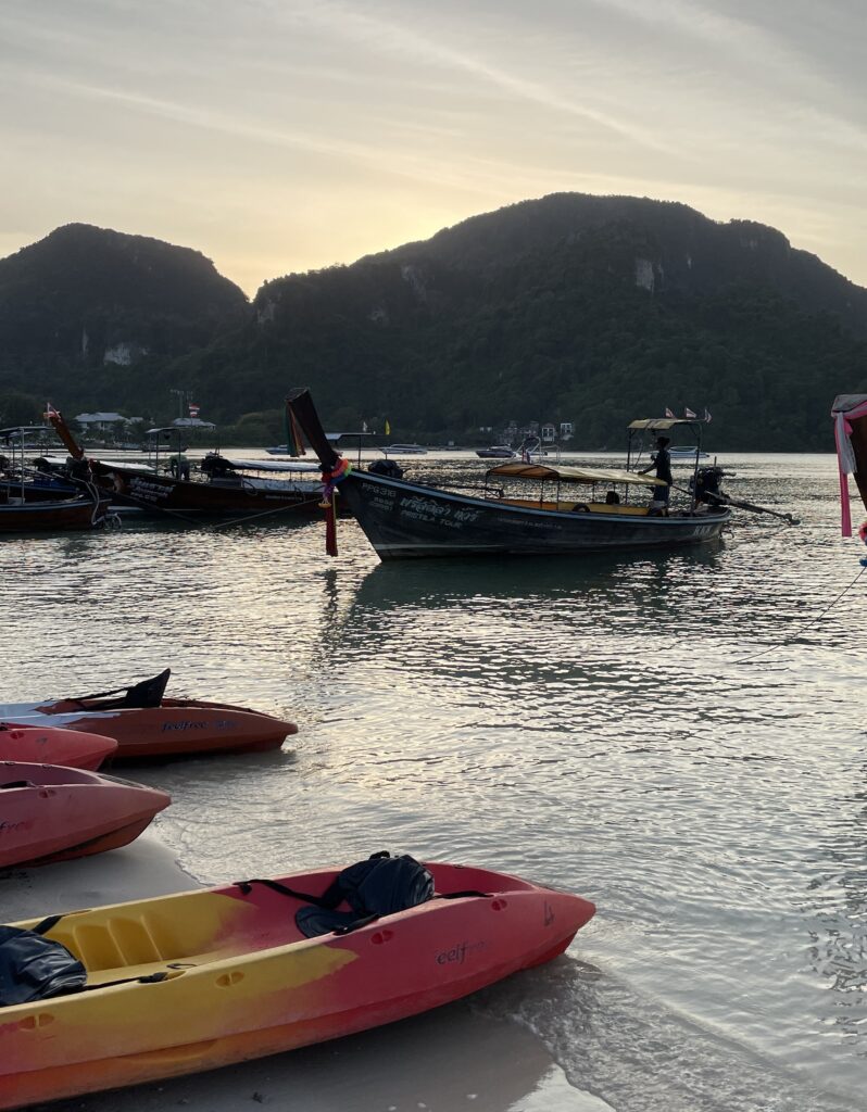 kayaks along the Loh Dalum beach shoreline at sunset 