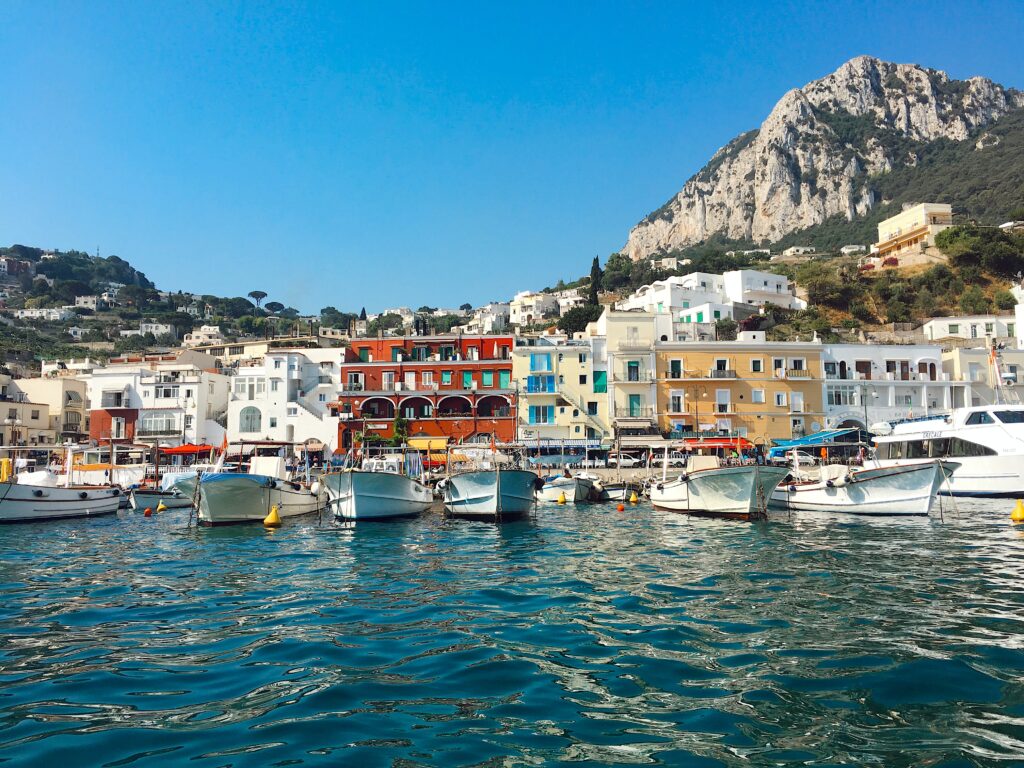 several yachts and boats docked at the main bay dock in Capri, Italy 