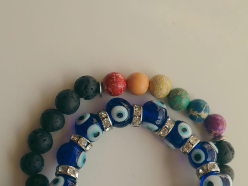 two simple bracelets, ones an evil eye bracelet 