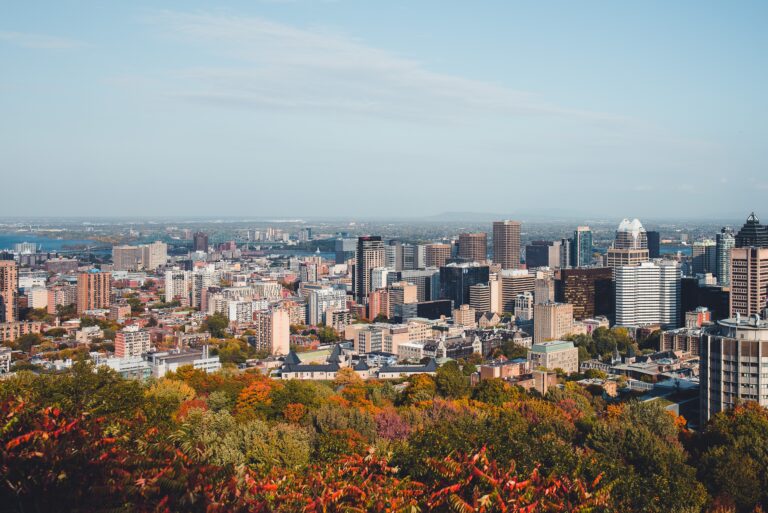 views of the Montreal skyline during Fall time, how to get from Toronto to Montreal