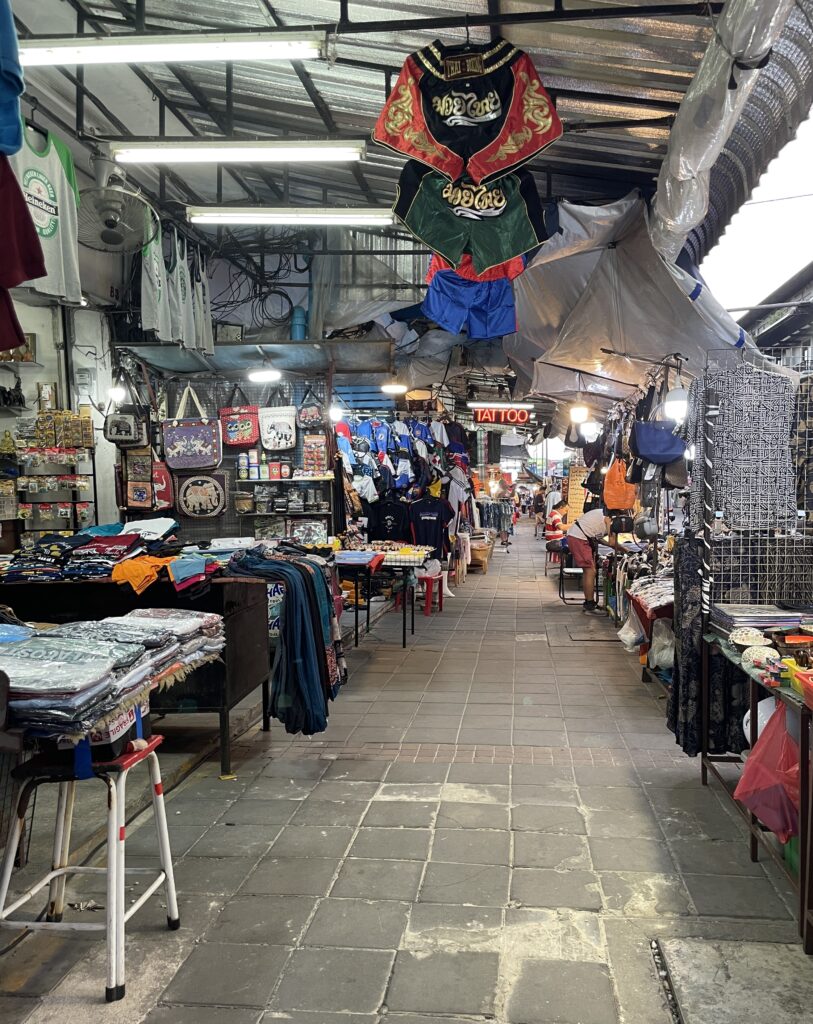 several various clothing items on display by many vendors at the Night Bazaar in Chiang Mai