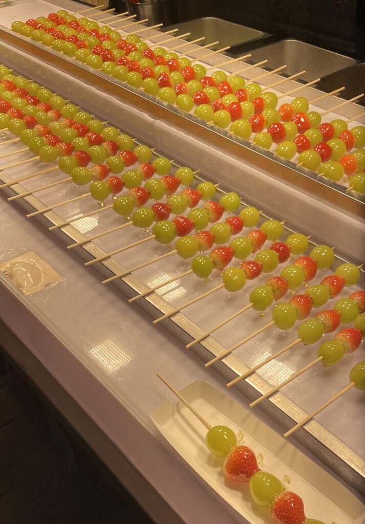 rows of sugar glazed sweet fruits at a vendors stall at the Myeongdong Night Market in Seoul, Korea 