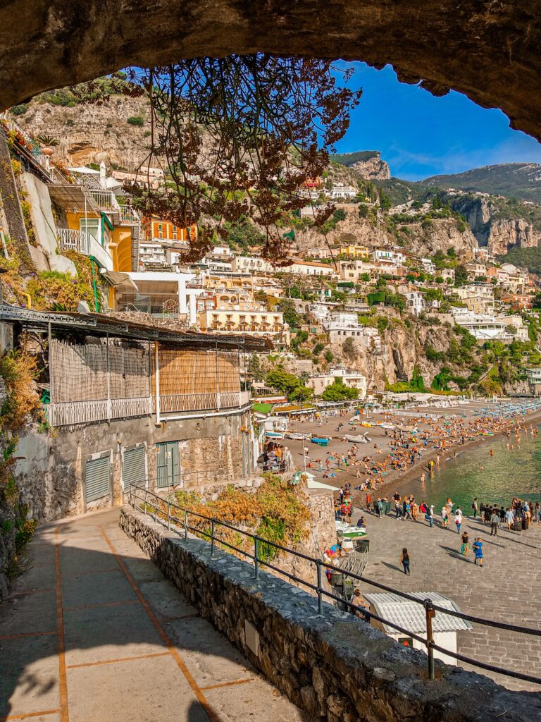 pathway leading to a stunning beach crowded beach on a Summer day in Positano 