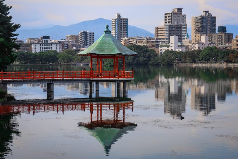 views of many buildings and a river walkway in Fukuoka, Japan / cheapest cities in Japan to visit or live