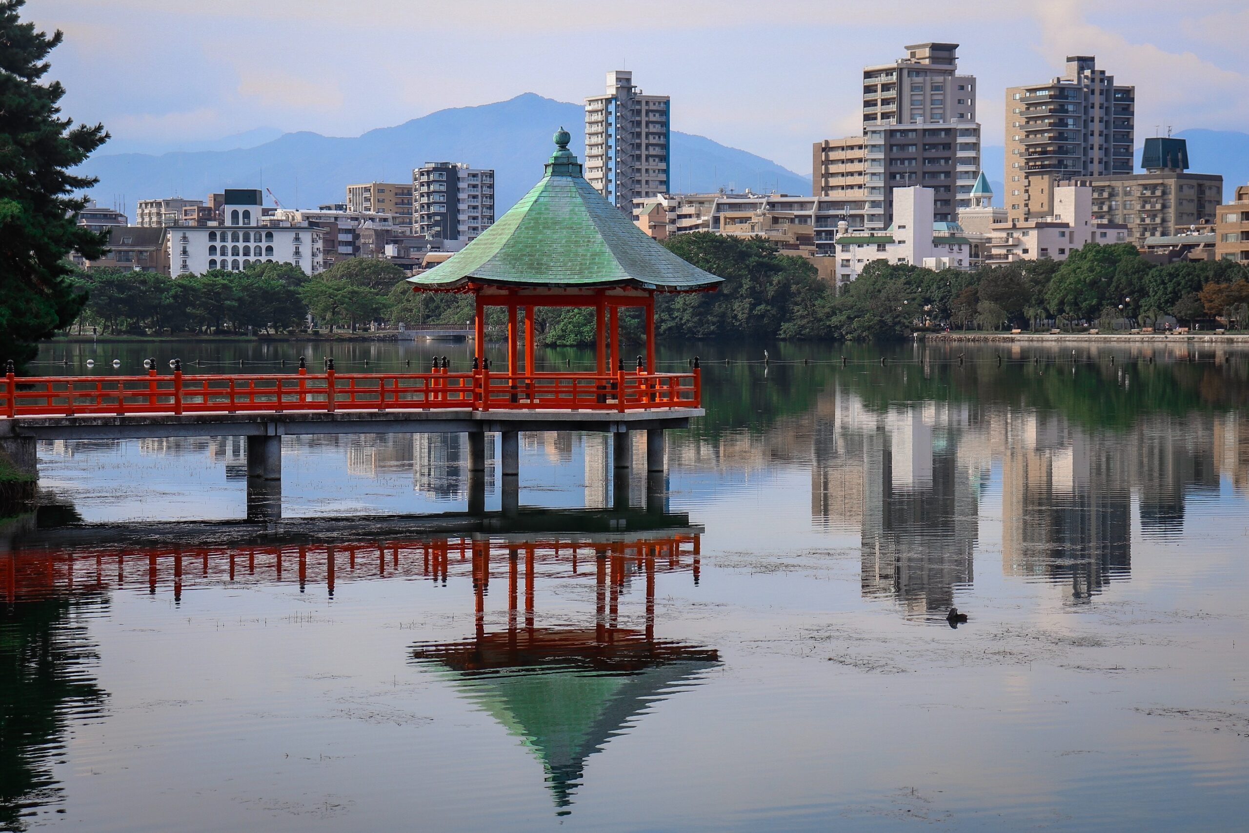 views of many buildings and a river walkway in Fukuoka, Japan / cheapest cities in Japan to visit or live