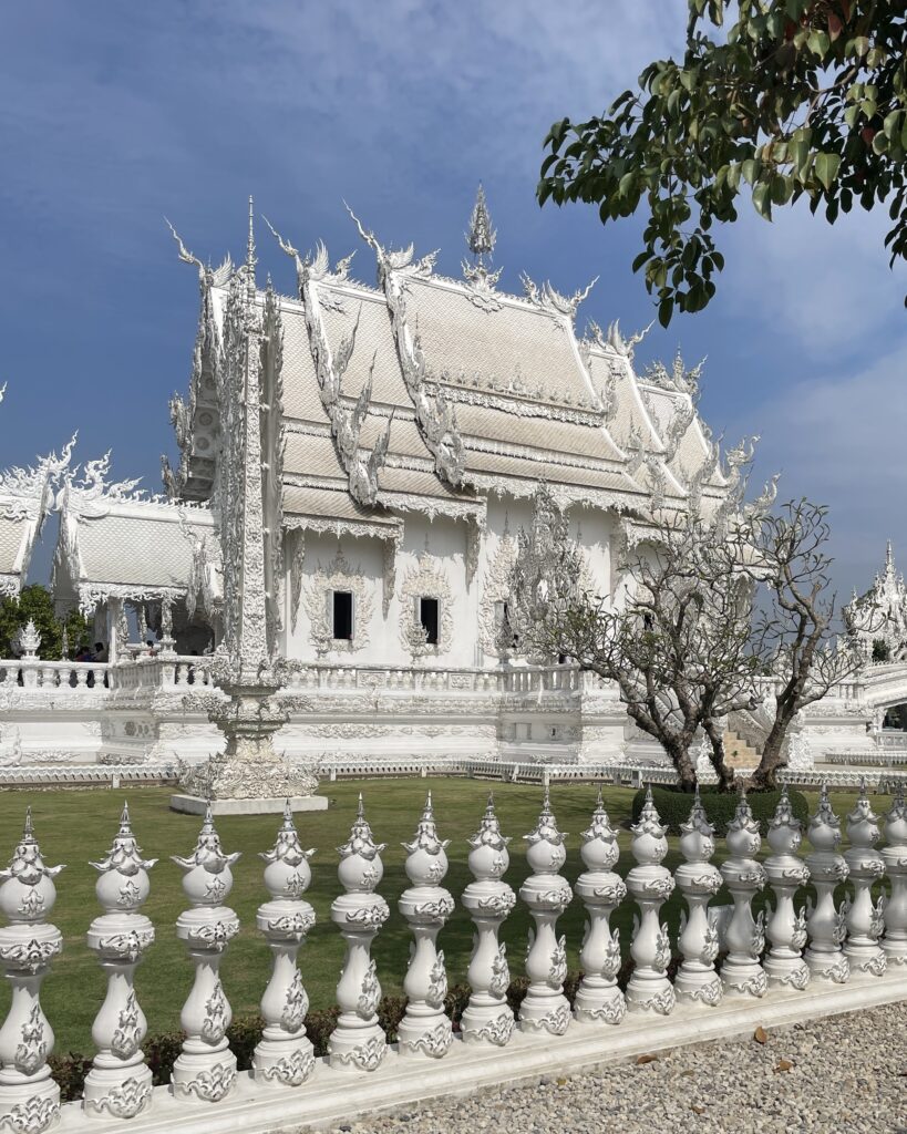a side angle of the stunning White Temple in Chiang Rai, Thailand 