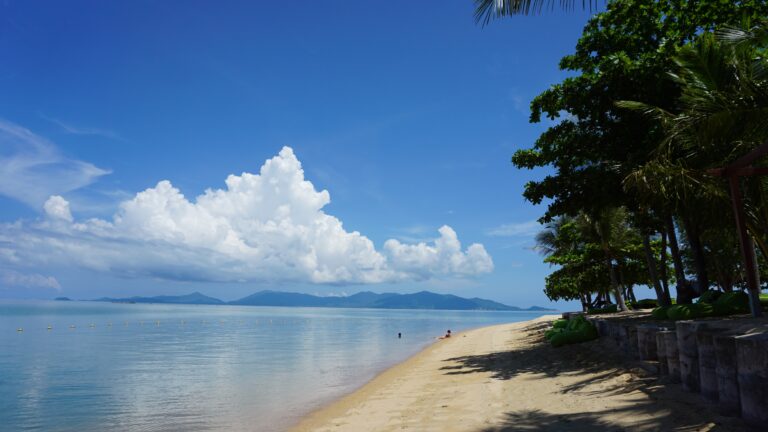 a quiet empty beach shoreline in Koh Samui on a beautiful sunny day