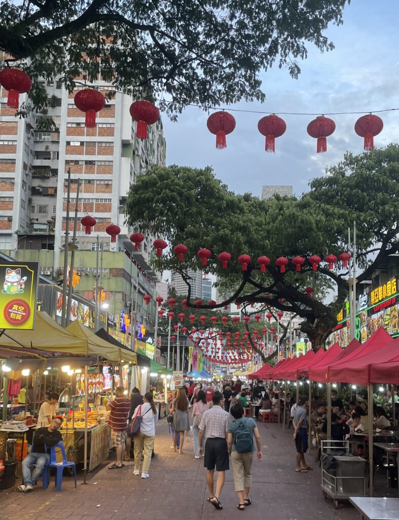 locals walking amongst the many food vendors at Jalan Alor Food Street in Kuala Lumpur 