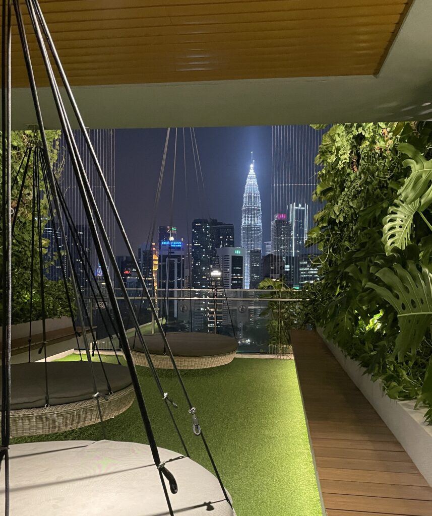 night views of the Petronas towers and Kuala Lumpur skyline from a residential condo observation deck 