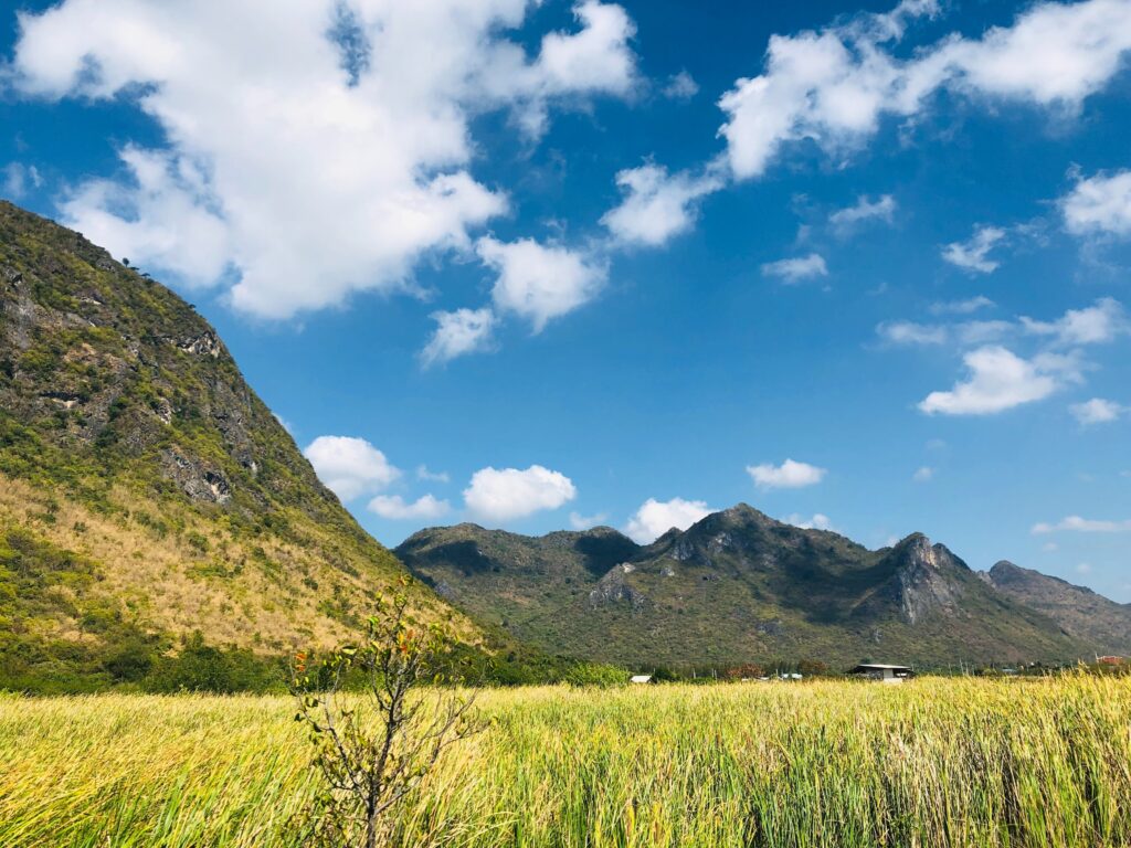 views of green firelds amongst mountains on a clear sunny day at Sam Roi Yod National Park