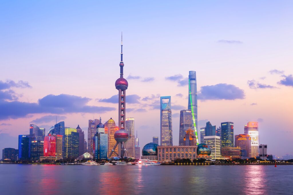 views of the Shanghai skyline along the water at sunset 