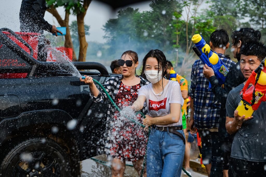 many locals spraying one another with water toys during Songkran festival in Thailand 