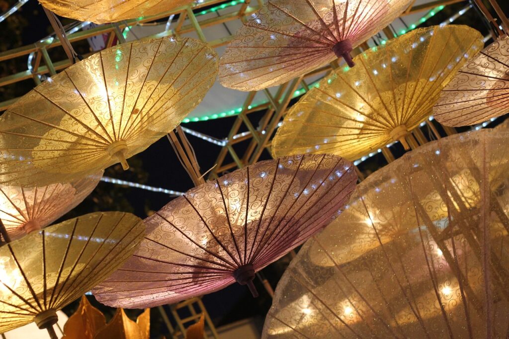 several illuminated umbrellas in the sky during the Umbrella Festival in Chiang Mai 