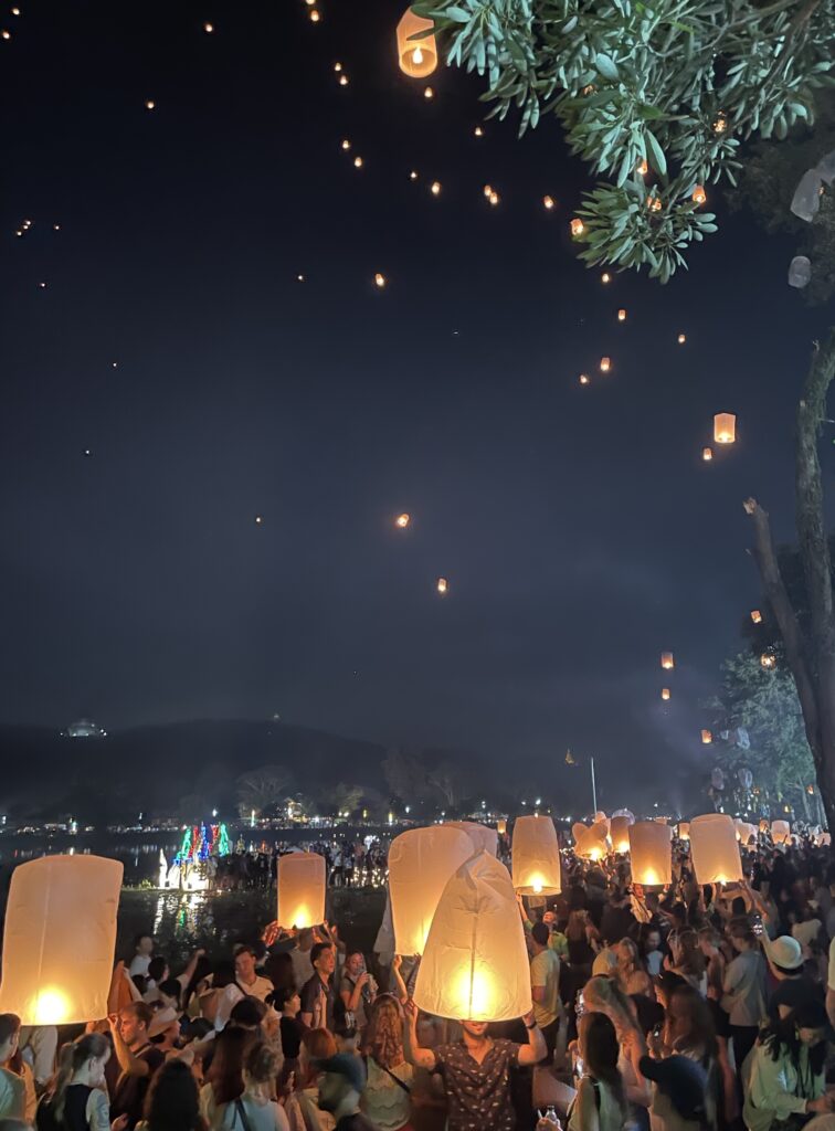 plenty of illuminated lanterns in the sky and lanterns being released during Yi Peng in Doi Saket  