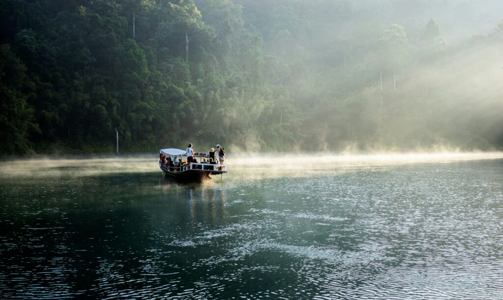 a boat with many passengers on it at Khao Sok National Park, Thailand 