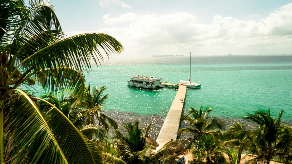a large boat in the distance along a dock in Isla Mujeres, Mexico 