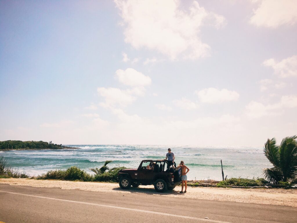 a jeep parked on the side of the road along the stunning coastline in Cozumel, Mexico 
