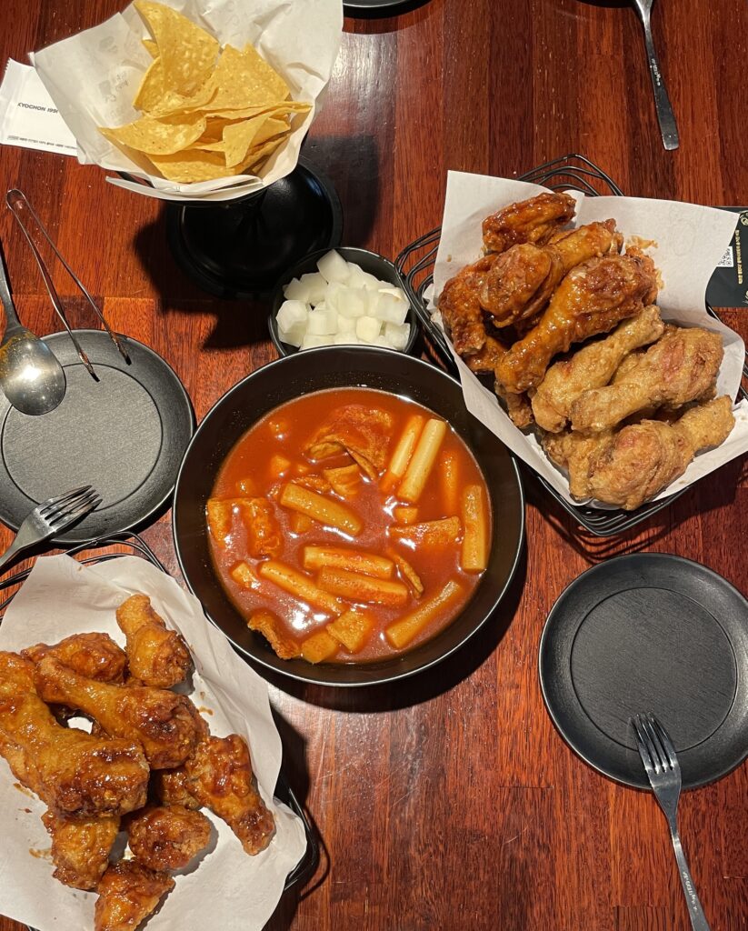 table spread of korean fried chicken, and a fish based soup at Kyochon restaurant in Insadong 